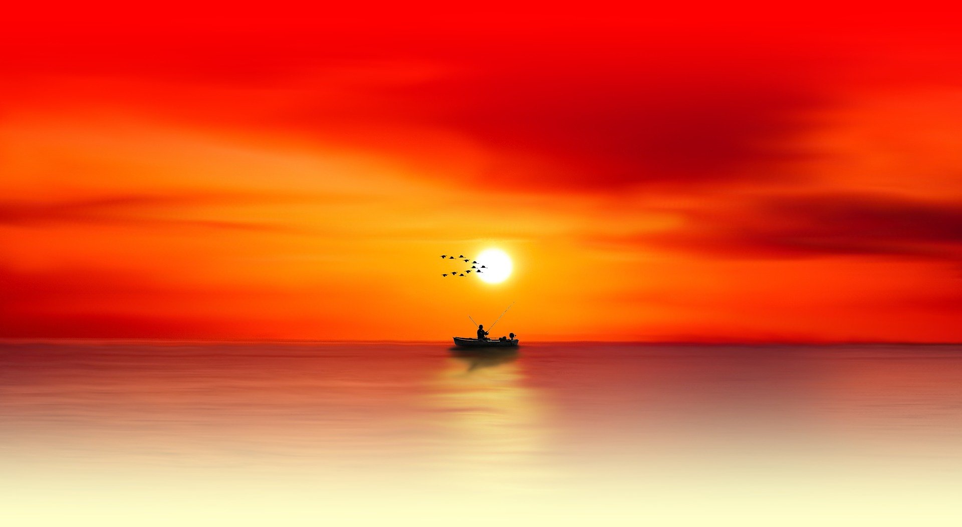Boat in an orange sunset at the sea